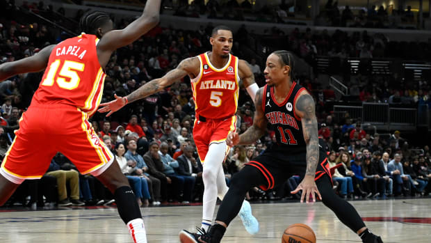 Chicago Bulls forward DeMar DeRozan dribbles the ball against Atlanta Hawks guard Dejounte Murray and center Clint Capela