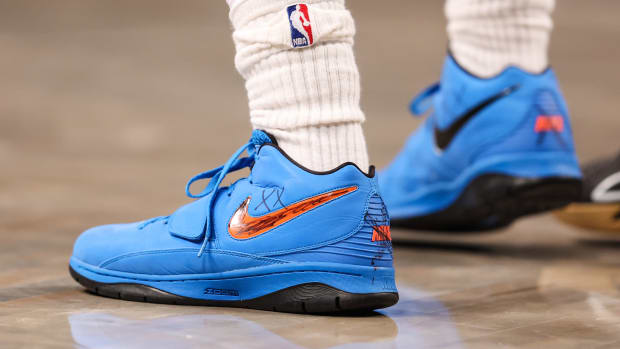 View of Kyrie Irving's blue and black Nike shoes.
