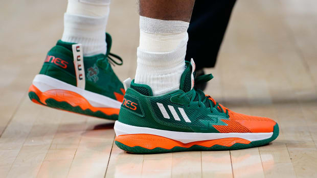 View of green and orange adidas shoes.