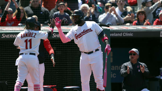 May 8, 2022; Cleveland, Ohio, USA; Cleveland Guardians Jose Ramirez (11) is high fived by Franmil Reyes (32) afer scoring in the third inning against the Toronto Blue Jays at Progressive Field. Guardians manager Terry Francona claps in the background. Mandatory Credit: Aaron Josefczyk-USA TODAY Sports