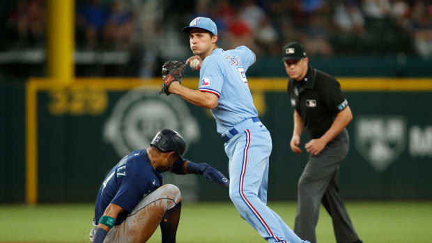 Jul 17, 2022; Arlington, Texas, USA; Texas Rangers shortstop Corey Seager (5) turns a double play as Seattle Mariners center fielder Julio Rodriguez (44) slides into second base in the third inning at Globe Life Field. Mandatory Credit: Tim Heitman-USA TODAY Sports