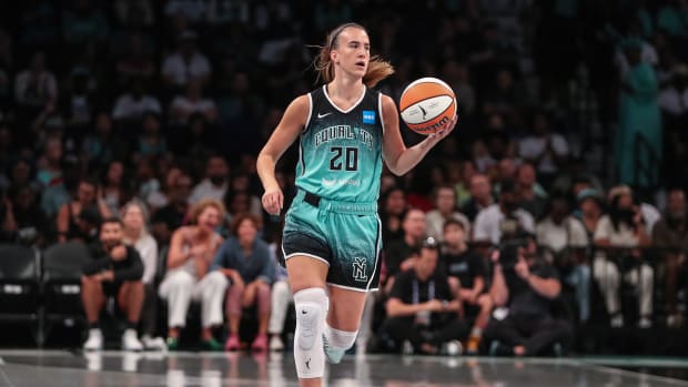 New York Liberty guard Sabrina Ionescu dribbles the ball up the court.