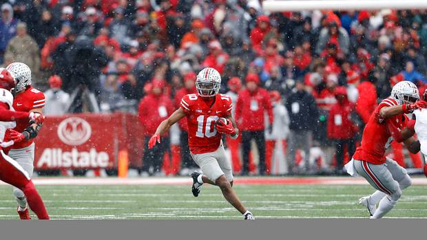 Xavier Johnson catches a screen pass and looks for a running lane.