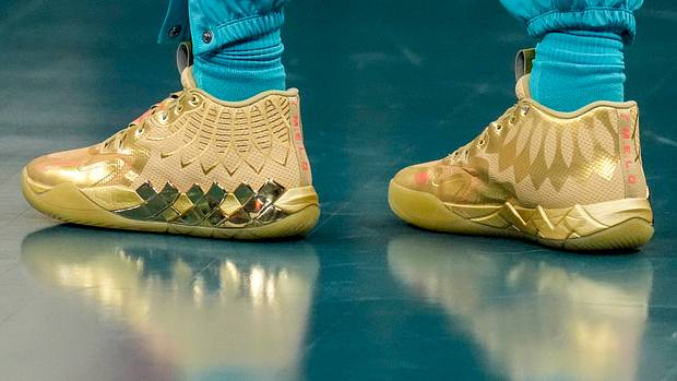 Charlotte Hornets guard LaMelo Ball's gold PUMA sneakers.