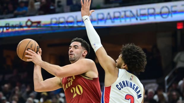 Nov 17, 2023; Cleveland, Ohio, USA; Cleveland Cavaliers forward Georges Niang (20) looks to pass as Detroit Pistons guard Cade Cunningham (2) defends during the first half at Rocket Mortgage FieldHouse.