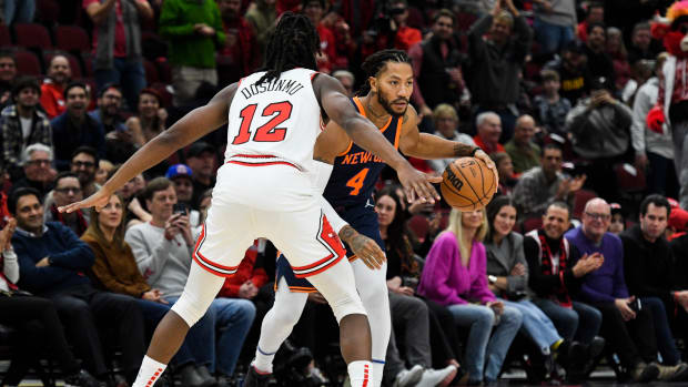 Dec 16, 2022; Chicago, Illinois, USA; New York Knicks guard Derrick Rose (4) dribbles the ball against Chicago Bulls guard Ayo Dosunmu (12) during the second half at the United Center.