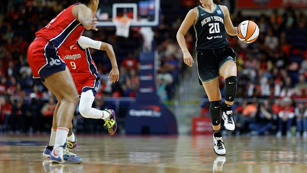 New York Liberty guard Sabrina Ionescu dribbles the basketball.