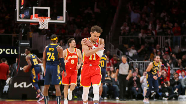 Mar 13, 2022; Atlanta, Georgia, USA; Atlanta Hawks guard Trae Young (11) shows emotion after a basket against the Indiana Pacers in the second quarter at State Farm Arena.