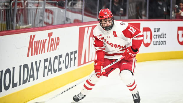Wisconsin forward Mathieu De St. Phalle (12) looks to pass the puck against Northeastern during the second period of the championship game of the Kwik Trip Holiday Face-Off on Friday, December 29, 2023, at Fiserv Forum in Milwaukee, Wisconsin.  