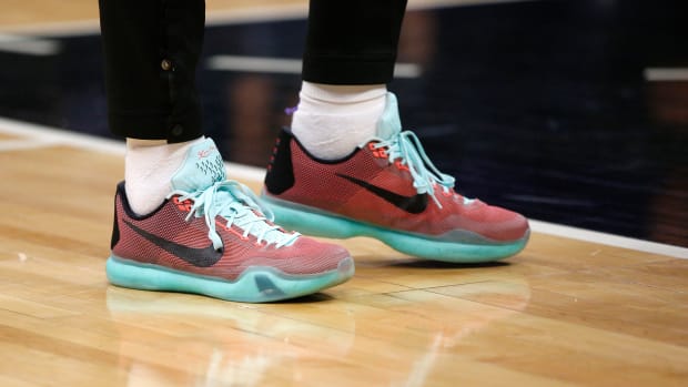 View of red and teal Nike Kobe shoes.