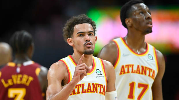 Apr 15, 2022; Cleveland, Ohio, USA; Atlanta Hawks guard Trae Young (11) reacts beside forward Onyeka Okongwu (17) in the fourth quarter against the Cleveland Cavaliers at Rocket Mortgage FieldHouse.