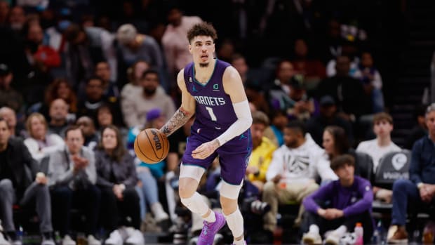 Charlotte Hornets guard LaMelo Ball dribbles the ball up the court.