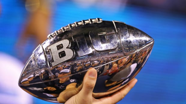 The Big Ten Championship Game Trophy being held up in celebration (Credit: Aaron Doster-USA TODAY Sports)