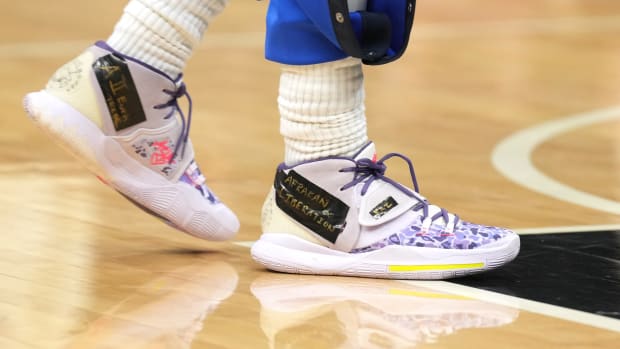 View of Kyrie Irving's purple Nike shoes.