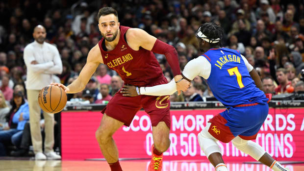 Nov 19, 2023; Cleveland, Ohio, USA; Cleveland Cavaliers guard Max Strus (1) drives against Denver Nuggets guard Reggie Jackson (7) in the fourth quarter at Rocket Mortgage FieldHouse. 