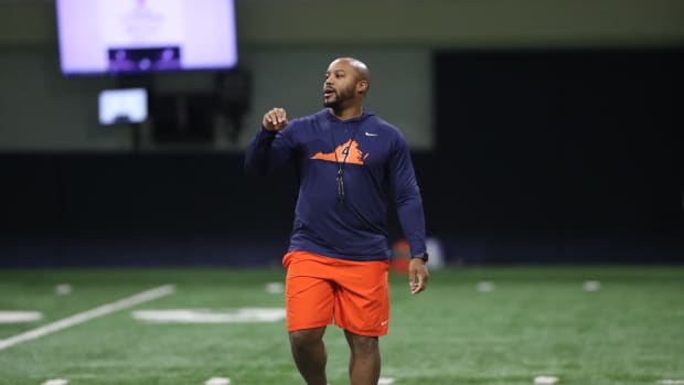 UVA wide receivers coach Adam Mims gives directions during a Virginia football practice at the George Welsh Indoor Practice Facility.