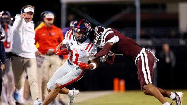 Nov 23, 2023; Starkville, Mississippi, USA; Mississippi Rebels wide receiver Jordan Watkins (11) runs after a catch for a first down as Mississippi State Bulldogs defensive back Marcus Banks (1) pushes him out of bounds during the second half at Davis Wade Stadium at Scott Field. Mandatory Credit: Petre Thomas-USA TODAY Sports