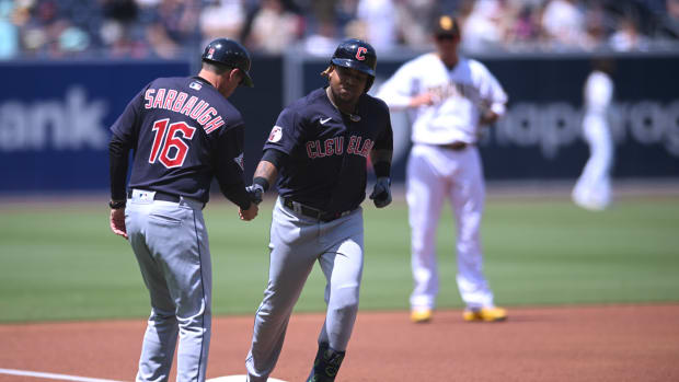 Aug 24, 2022; San Diego, California, USA; Cleveland Guardians third baseman Jose Ramirez (center) is congratulated by third base coach Mike Sarbaugh (16) after hitting a home run during the first inning against the San Diego Padres at Petco Park. Mandatory Credit: Orlando Ramirez-USA TODAY Sports