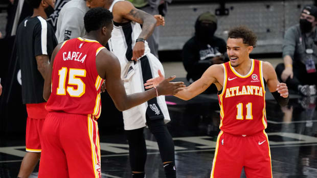 Atlanta Hawks center Clint Capela (15) and guard Trae Young (11) celebrate after their double overtime victory over the San Antonio Spurs at AT&T Center.
