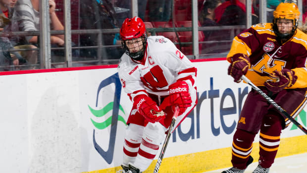 Women's hockey star Hilary Knight skating maneuvering down the ice against Minnesota