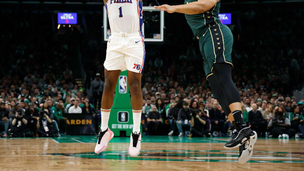 76ers guard James Harden shoots over Celtics forward Grant Williams.