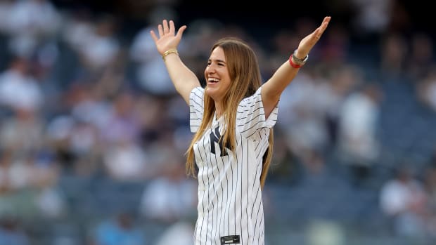 Sabrina Ionescu reacts after throwing out a ceremonial first pitch at a New York Yankees game.