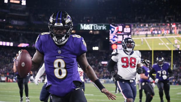 Ravens quarterback Lamar Jackson runs the ball to score a touchdown against Houston Texans defensive tackle Sheldon Rankins during the fourth quarter of a 2024 AFC divisional round game at M&T Bank Stadium.