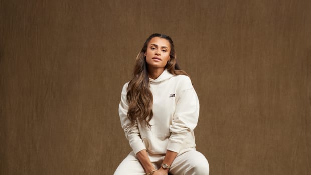 Sydney McLaughlin-Levrone sits on a stool in a New Balance photo shoot.