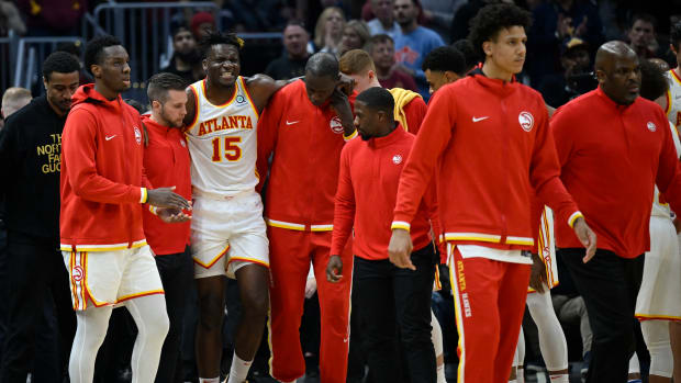 Apr 15, 2022; Cleveland, Ohio, USA; Atlanta Hawks center Clint Capela (15) is helped off the court in the second quarter against the Cleveland Cavaliers at Rocket Mortgage FieldHouse.
