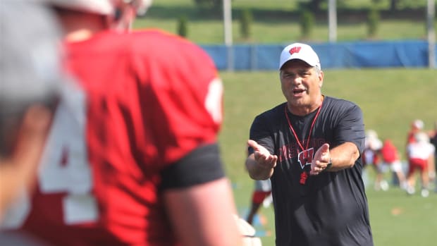 Wisconsin offensive line coach Jack Bicknell Jr. talks with his players during practice on Aug. 6, 2023 at Pioneer Stadium in Platteville, Wis.  