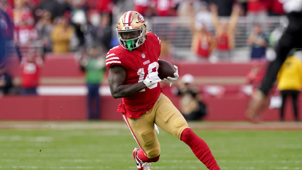 San Francisco 49ers wide receiver Deebo Samuel runs with the ball.