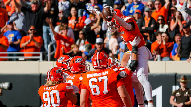 Oct 14, 2023; Stillwater, Oklahoma, USA; Oklahoma State's Ollie Gordon II (0) celebrates with teammates after scoring a touchdown against the Kansas Jayhawks during the second quarter at Boone Pickens Stadium. Mandatory Credit: Nathan J. Fish-USA TODAY Sports