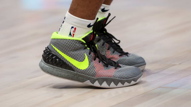 Grey and green Nike Kyrie shoes.
