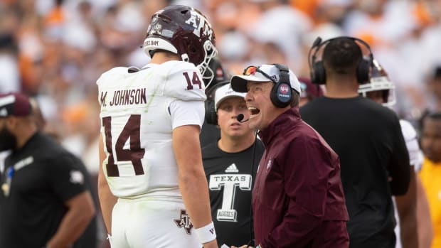 Texas A&M quarterback Max Johnson (14) is yelled to by Texas A&M head coach Jimbo Fisher during a football game between Tennessee and Texas A&M at Neyland Stadium in Knoxville, Tenn., on Saturday.