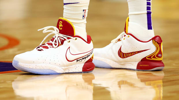 Los Angeles Lakers forward LeBron James' white, cardinal, and gold Nike sneakers.