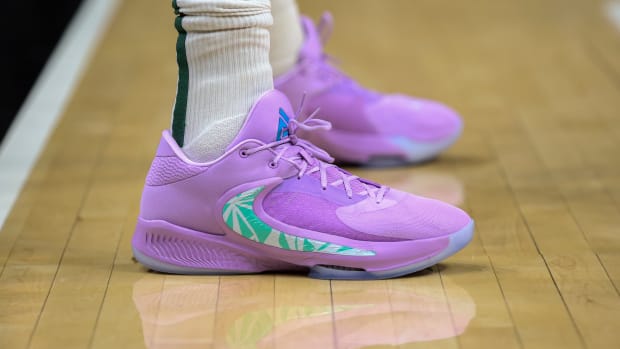 View of Giannis Antetokounmpo's purple and green Nike shoes.