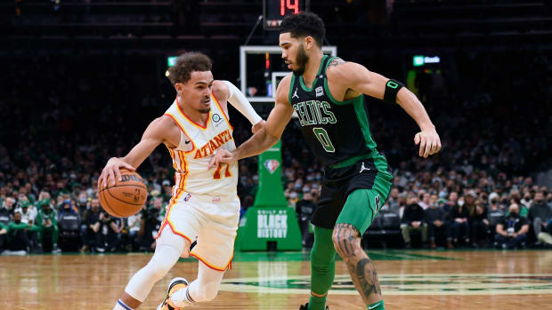 Celtics forward Jayson Tatum defends Hawks guard Trae Young.