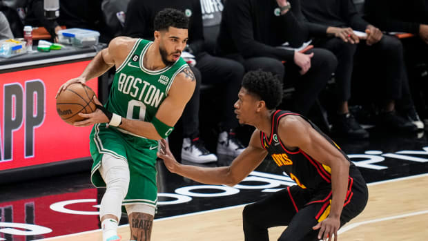 Boston Celtics forward Jayson Tatum controls the ball against Atlanta Hawks forward De'Andre Hunter.