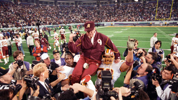 Washington Redskins head coach Joe Gibbs is carried on the field after defeating the Buffalo Bills during Super Bowl XXVI at the Metrodome. The Redskins defeated the Bills 37-24. Mandatory Credit: RVR Photos-USA TODAY Sports