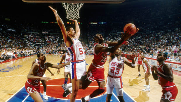 May 1989; Detroit, MI, USA: FILE PHOTO; Chicago Bulls guard Michael Jordan (23) is defended by Detroit Pistons center James Edwards (53) during the 1988-89 NBA Eastern Conference Finals at The Palace.