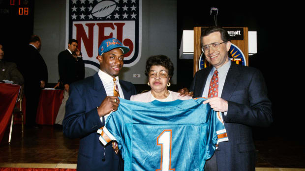 Troy Vincent standing with a Miami Dolphins jersey during the NFL Draft (Credit: RVR Photos-USA TODAY Sports)
