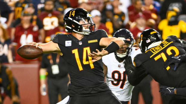 Washington Commanders quarterback Sam Howell (14) drops back to pass as Chicago Bears defensive end Yannick Ngakoue (91) rushes during the second half at FedExField.