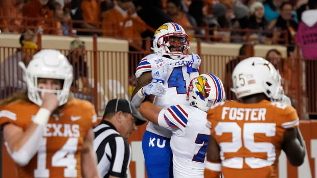 Nov 13, 2021; Austin, Texas, USA; Kansas Jayhawks running back Devin Neal (4) is lifted by offensive lineman Bryce Cabeldue after scoring a touchdown during the first half against the Texas Longhorns at Darrell K Royal-Texas Memorial Stadium. Mandatory Credit: Scott Wachter-USA TODAY Sports