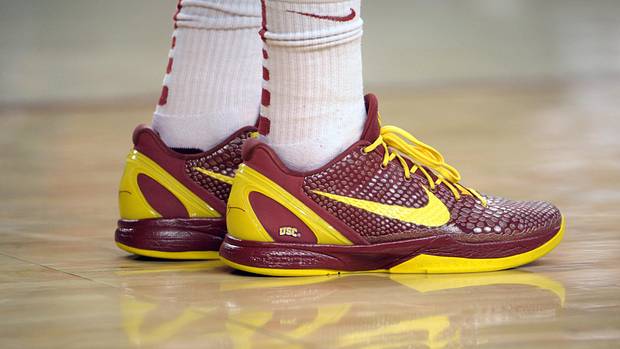 USC Trojans' cardinal and gold Nike Kobe sneakers.