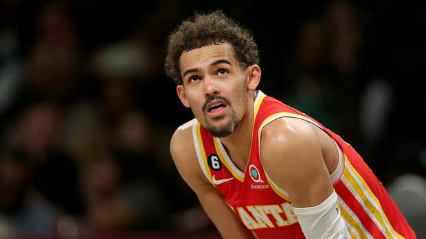 Trae Young looks at the scoreboard during a game.