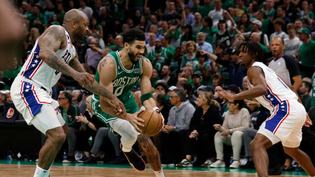 Philadelphia 76ers forward P.J. Tucker defends Boston Celtics forward Jayson Tatum.