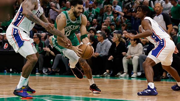 Philadelphia 76ers forward P.J. Tucker defends Boston Celtics forward Jayson Tatum.