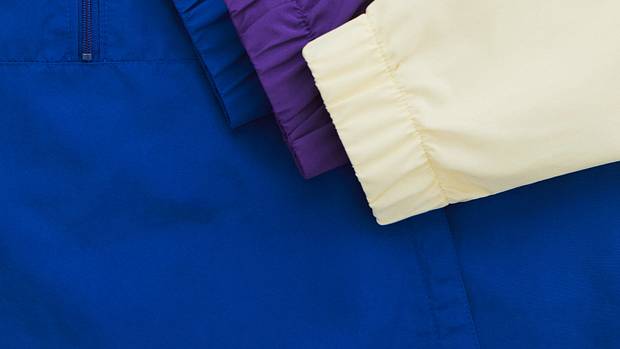 Blue, purple, and cream New Balance sweatshirts.