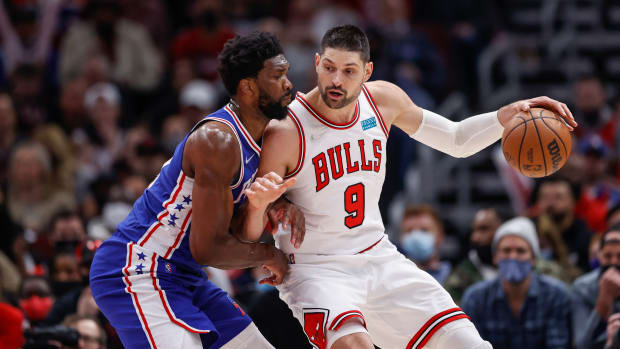 Feb 6, 2022; Chicago, Illinois, USA; Chicago Bulls center Nikola Vucevic (9) is defended by Philadelphia 76ers center Joel Embiid (21) during the second half at United Center.