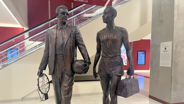 The statue of Bill Garrett (right) and coach Branch McCracken (left) stands in the south lobby of Simon Skjodt Assembly Hall in Bloomington, Ind. 